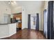 Open-concept living area with hardwood floors, vaulted ceiling, and view into the kitchen at 6017 Westgate Dr # 924, Orlando, FL 32835