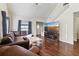Cozy living room featuring a stairway, high ceiling, hardwood floors, and a wall-mounted TV at 6017 Westgate Dr # 924, Orlando, FL 32835
