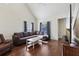 Inviting living room with hardwood floors, a large brown sofa, and plenty of natural light at 6017 Westgate Dr # 924, Orlando, FL 32835
