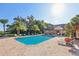 A beautiful community pool surrounded by swaying palms and lounge chairs, providing a serene oasis for relaxation at 6017 Westgate Dr # 924, Orlando, FL 32835