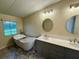Elegant bathroom featuring a freestanding tub, dual sinks, and modern fixtures at 4861 Myrtle View N Dr, Mulberry, FL 33860