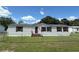 Charming single-story home with light siding, brown shutters, and well-maintained front yard at 4861 Myrtle View N Dr, Mulberry, FL 33860