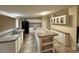 Bright kitchen featuring white cabinets, an island with breakfast bar, and ample counter space at 4861 Myrtle View N Dr, Mulberry, FL 33860