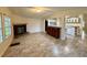 Comfortable living room with a fireplace, adjacent to the kitchen and dining area at 4861 Myrtle View N Dr, Mulberry, FL 33860