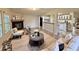 Inviting living room with fireplace, neutral color palette, and open concept design to kitchen at 4861 Myrtle View N Dr, Mulberry, FL 33860