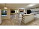 Open living space showcasing a kitchen island and seamlessly connecting to a living area at 4861 Myrtle View N Dr, Mulberry, FL 33860