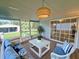 Inviting sunroom with stylish decor and sliding glass doors leading to the outdoors at 4861 Myrtle View N Dr, Mulberry, FL 33860