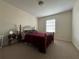 Bedroom with a cozy bed, neutral carpet, and natural light from the window at 223 Windsor St # 6, Lakeland, FL 33803