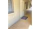 Hallway of a condo featuring a tiled floor, windows, and unit number six at 223 Windsor St # 6, Lakeland, FL 33803