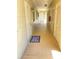 Hallway of a condo featuring a tiled floor, windows, and multiple doors to the different units at 223 Windsor St # 6, Lakeland, FL 33803