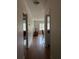 Hallway showcasing a living room view and adjacent dining space, emphasizing the home's layout at 223 Windsor St # 6, Lakeland, FL 33803