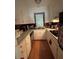 Galley kitchen boasting white cabinets, modern appliances, and efficient counter space at 223 Windsor St # 6, Lakeland, FL 33803
