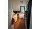 Galley kitchen with white cabinets, stainless steel appliances, and wood flooring at 223 Windsor St # 6, Lakeland, FL 33803