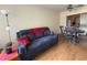Living room featuring a comfortable blue sofa, wood flooring, and dining area at 223 Windsor St # 6, Lakeland, FL 33803