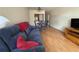 Living room with a comfortable blue sofa and hardwood flooring at 223 Windsor St # 6, Lakeland, FL 33803