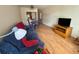 Living room featuring a blue sofa, hardwood floors, and dining area at 223 Windsor St # 6, Lakeland, FL 33803