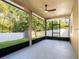 Enclosed back porch overlooking the backyard with a ceiling fan at 10084 Moss Rose Way, Orlando, FL 32832