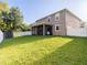 Expansive back yard featuring a screened lanai, white fencing, and a practical storage shed, blending comfort at 10084 Moss Rose Way, Orlando, FL 32832