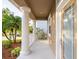 View of the front porch showing white columns and landscaping at 10084 Moss Rose Way, Orlando, FL 32832