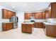 The kitchen features wood cabinets, stainless steel appliances, and a center island at 10084 Moss Rose Way, Orlando, FL 32832