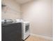 Laundry room featuring a modern washer and dryer and wire shelving at 10084 Moss Rose Way, Orlando, FL 32832