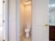 Small toilet room with a standard toilet and neutral color walls at 10084 Moss Rose Way, Orlando, FL 32832