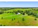 Expansive aerial view showcasing a charming home nestled amidst lush greenery and serene landscapes at 2440 S Wallace Rd, Bartow, FL 33830