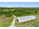 Aerial view showing long driveway leading to home and outbuilding at 2440 S Wallace Rd, Bartow, FL 33830