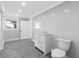 Bright bathroom featuring modern fixtures, marble walls, and a sleek vanity at 2440 S Wallace Rd, Bartow, FL 33830