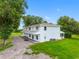 Two-story home featuring a spacious driveway and well-maintained lawn with mature trees at 2440 S Wallace Rd, Bartow, FL 33830