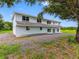 Inviting two-story home with lush green surroundings, providing a peaceful and picturesque backdrop at 2440 S Wallace Rd, Bartow, FL 33830