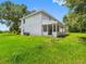 Well-maintained home exterior with covered patio and lush green lawn, enhancing its curb appeal at 2440 S Wallace Rd, Bartow, FL 33830