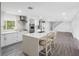 Modern kitchen with a center island, stainless steel appliances, and a seamless flow to the living space at 2440 S Wallace Rd, Bartow, FL 33830
