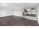 Open-concept living room with hardwood floors leading to a bright, modern kitchen at 2440 S Wallace Rd, Bartow, FL 33830