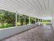 Expansive covered patio with tiled flooring, perfect for outdoor entertaining and enjoying scenic views at 2440 S Wallace Rd, Bartow, FL 33830