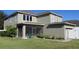 A view of the rear exterior of the property, showcasing a screened lanai, lawn, and a private backyard space at 6832 Thornhill Cir, Windermere, FL 34786