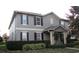 Charming two-story home featuring a well-manicured front yard and a welcoming front porch at 6832 Thornhill Cir, Windermere, FL 34786