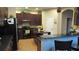 Well-equipped kitchen featuring dark wood cabinets, granite countertops, and a kitchen island at 6832 Thornhill Cir, Windermere, FL 34786