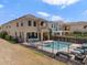 Backyard view showing pool, patio furniture and the exterior of the property at 852 Desert Mountain Ct, Reunion, FL 34747