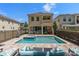 Backyard featuring a large pool and hot tub and covered patio area at 852 Desert Mountain Ct, Reunion, FL 34747