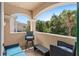 Covered balcony featuring a seating area with wooded views at 852 Desert Mountain Ct, Reunion, FL 34747