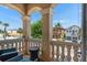 Balcony featuring comfortable outdoor seating with stone columns and street view at 852 Desert Mountain Ct, Reunion, FL 34747