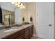 Bathroom featuring double vanity with granite countertops and a separate glass enclosed shower at 852 Desert Mountain Ct, Reunion, FL 34747
