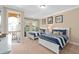 Bright bedroom with two twin beds, balcony access and neutral walls at 852 Desert Mountain Ct, Reunion, FL 34747