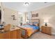 Tastefully decorated bedroom with a comfortable bed, stylish decor, and ensuite bathroom access at 852 Desert Mountain Ct, Reunion, FL 34747