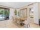 Inviting dining area with tile flooring, sliding glass doors to the pool and an elegant glass-topped dining table at 852 Desert Mountain Ct, Reunion, FL 34747