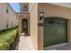 Close up of a tan house with a green door and garage at 852 Desert Mountain Ct, Reunion, FL 34747