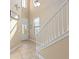 Bright foyer with tiled floor, staircase, and front door with glass insert at 852 Desert Mountain Ct, Reunion, FL 34747