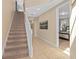 Inviting hallway with carpeted stairs, neutral paint, and tiled floor leading to the bedrooms at 852 Desert Mountain Ct, Reunion, FL 34747