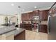 Spacious kitchen featuring dark cabinets, granite countertops, and stainless steel appliances at 852 Desert Mountain Ct, Reunion, FL 34747